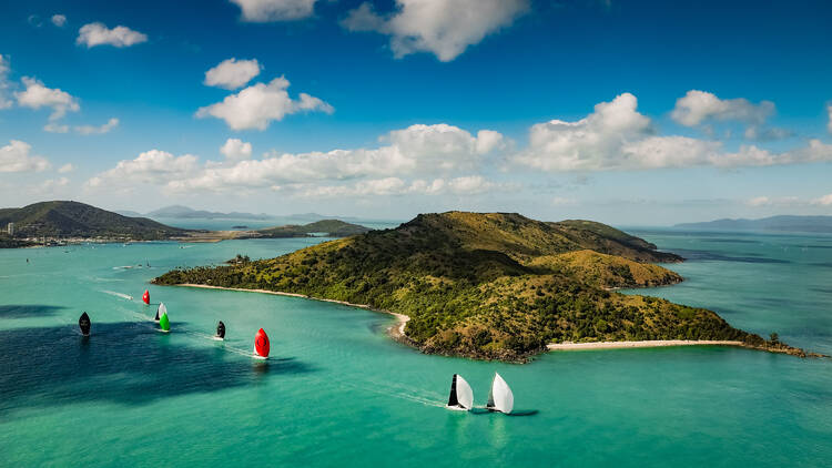 Yachts sailing near island