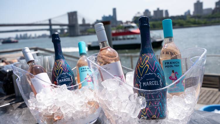 Bottles of rose in ice buckets.