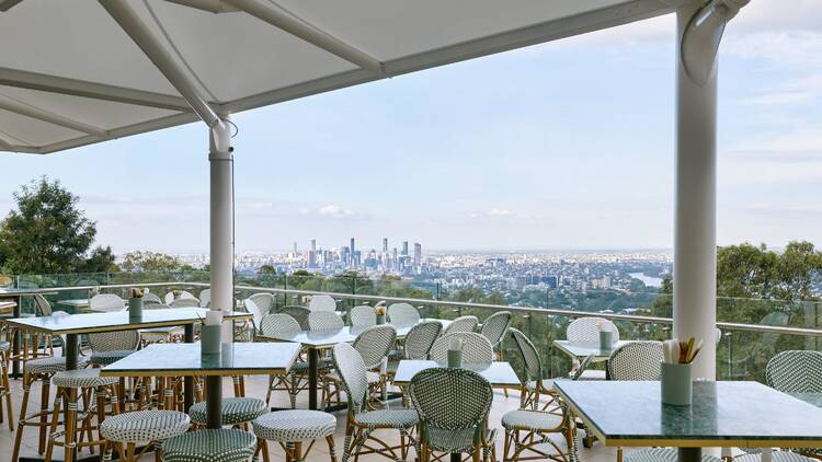 View of city skyline from verandah with restaurant seating
