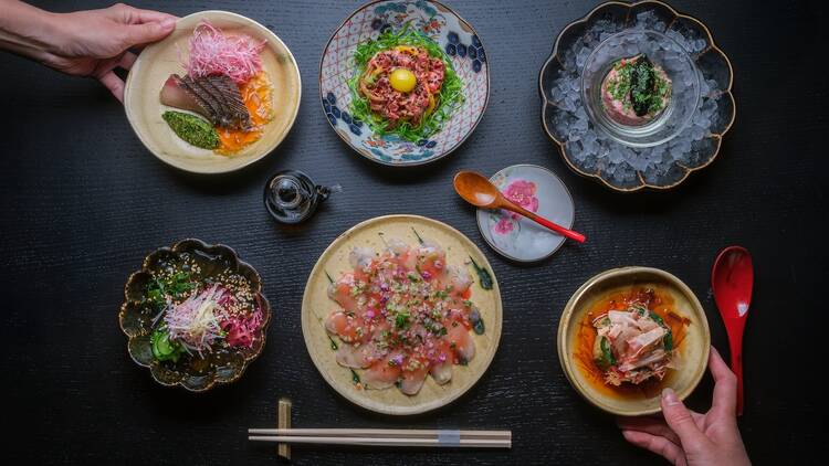 Six dishes on a black table