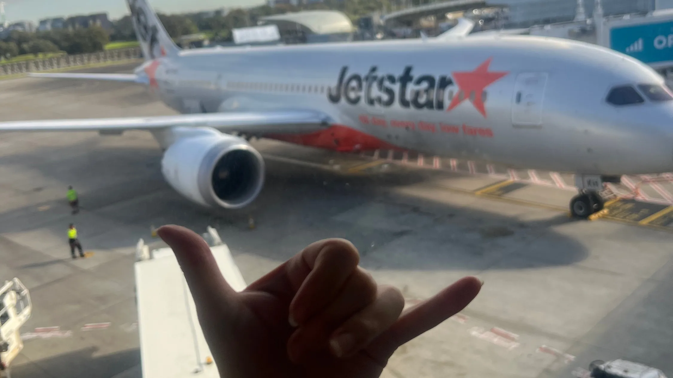 Avril doing a shucka in front of a plane
