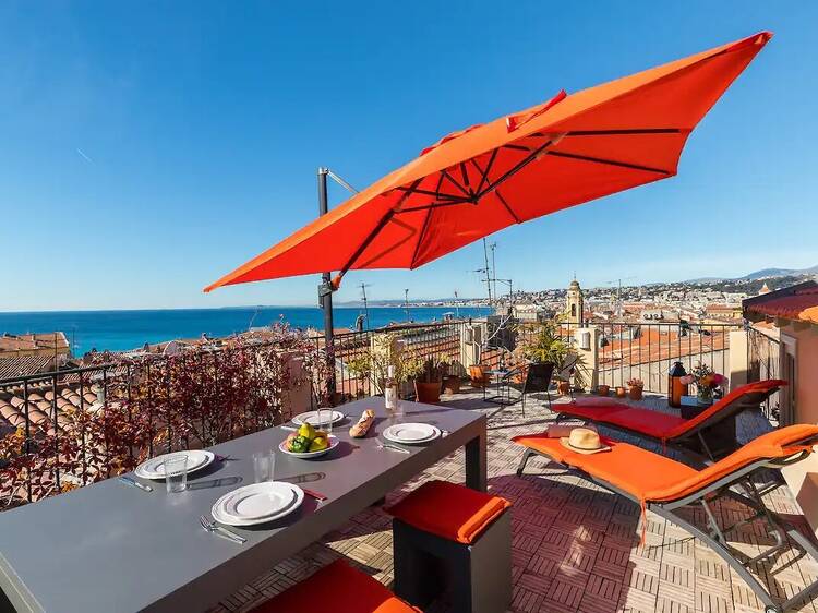 nice airbnb private terrace with orange umbrella