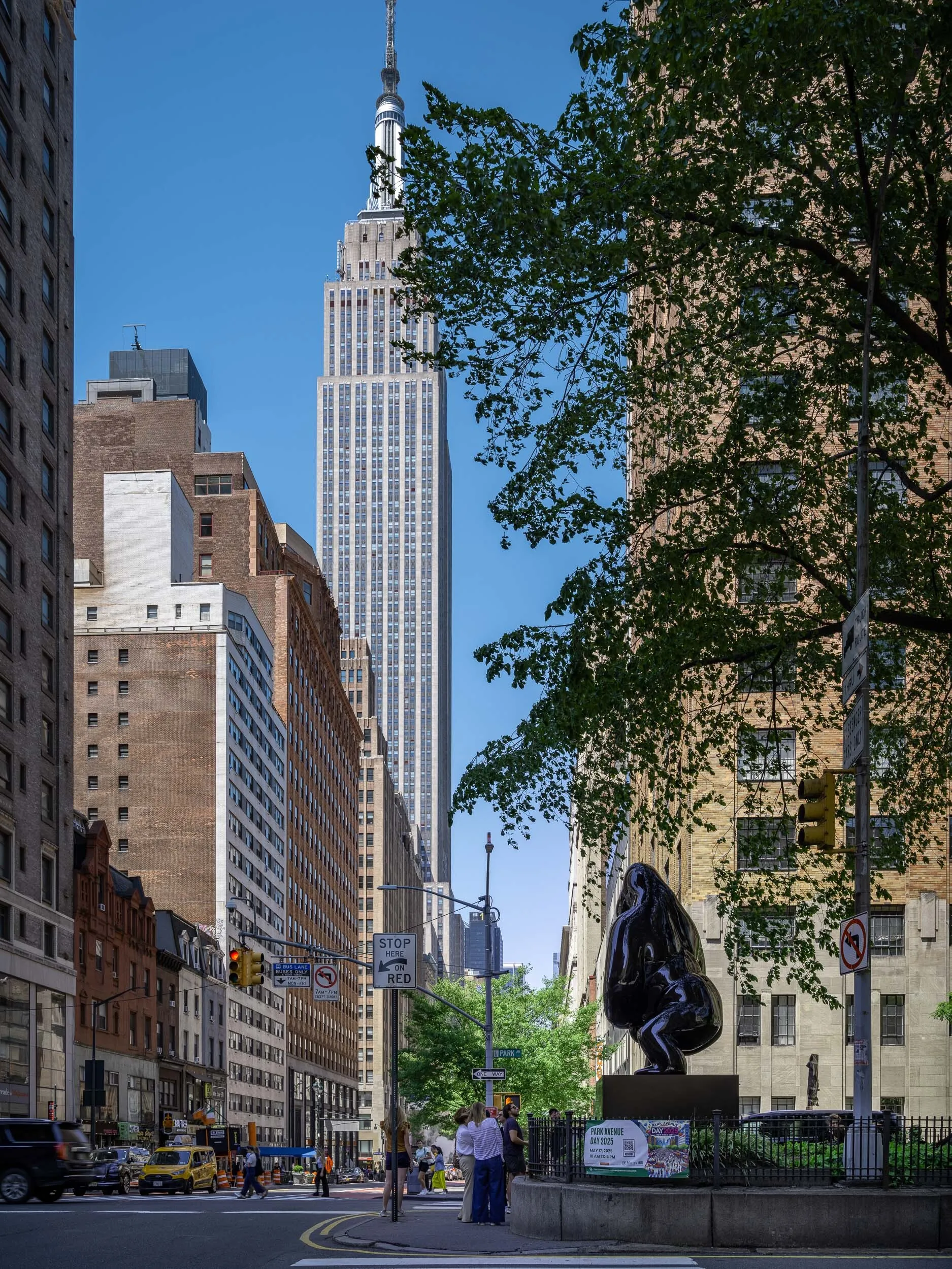 A statue of a gorilla looks toward the Empire State Building.