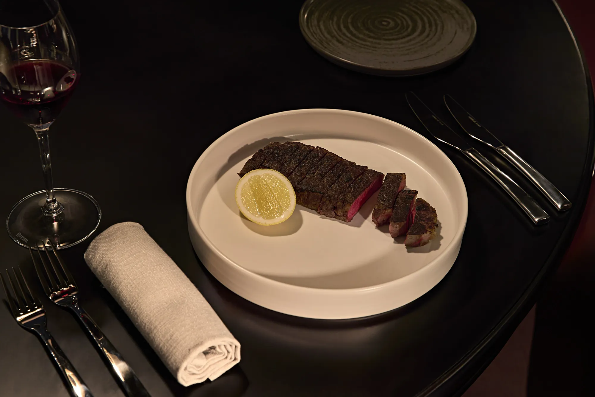 Steak with a half of lemon.