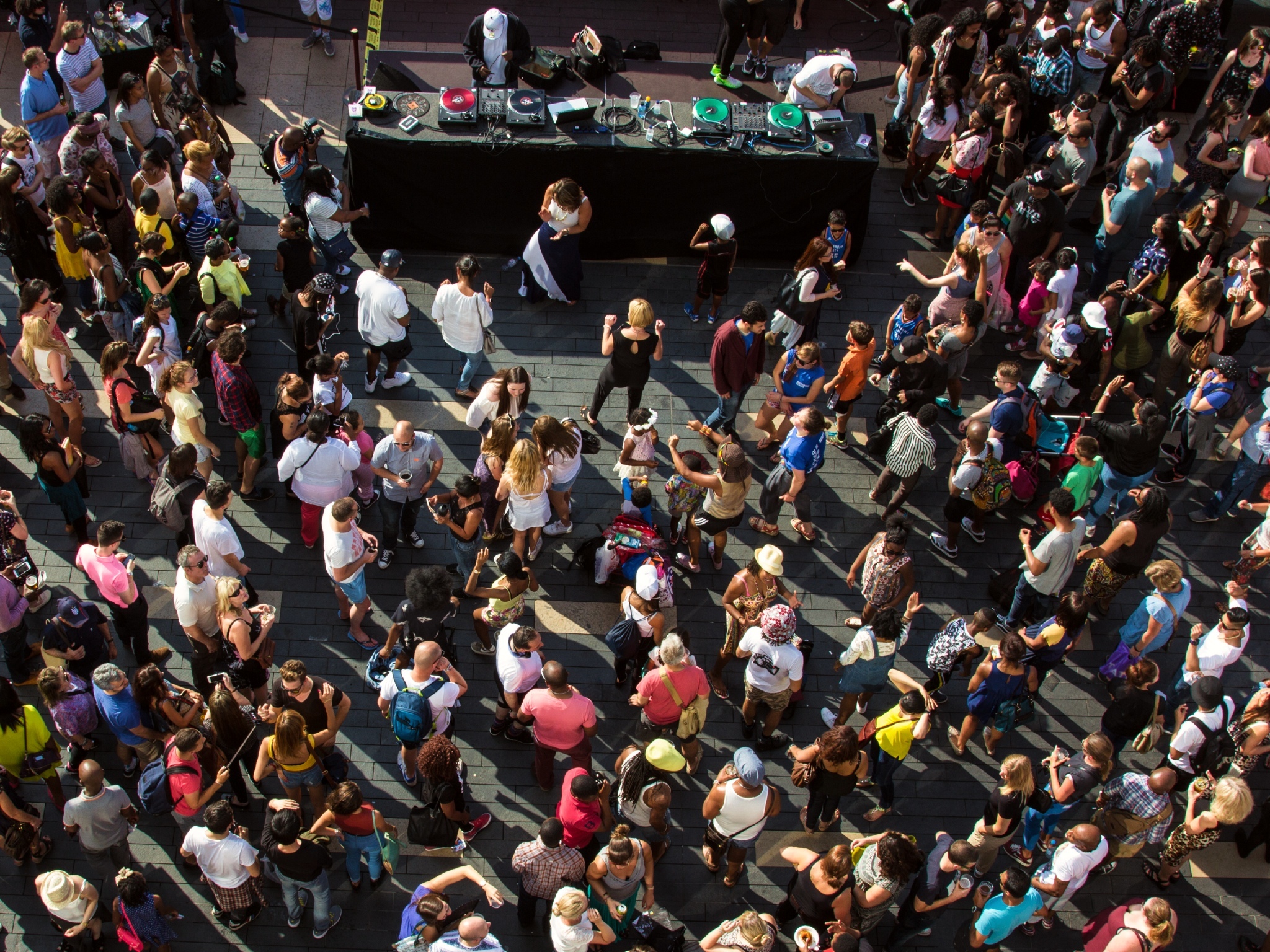 Aerial shot of a large crowd dancing in front of DJ decks on the terrace at the Southbank Centre