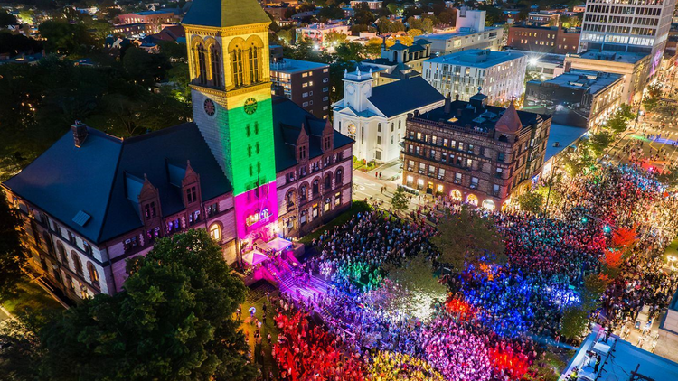 sky view of building with crowds and rainbow lighting sky view of building with crowds and rainbow lighting
