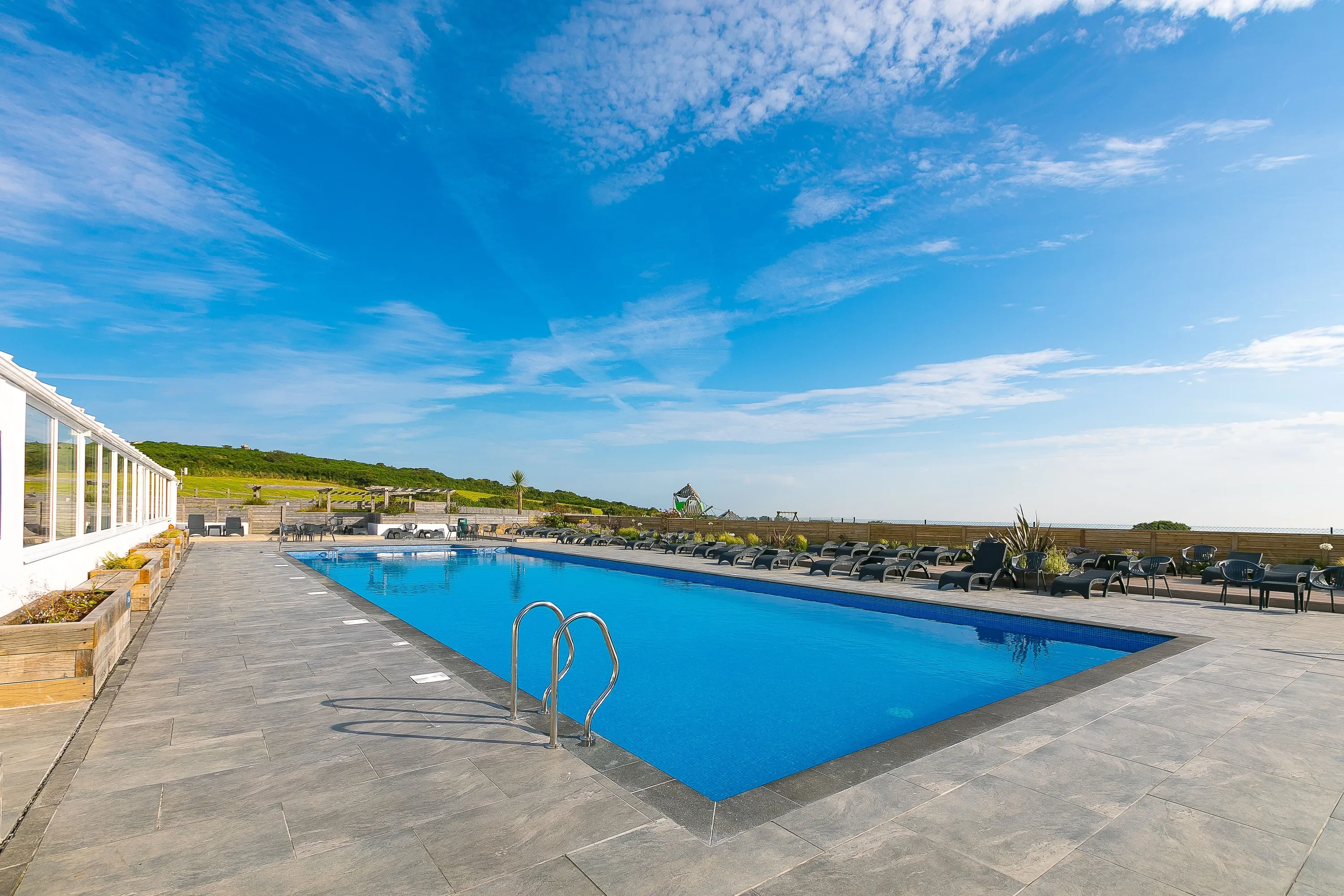 Outside pool area of Polmanter Touring Park, in Halsetown, Cornwall. VisitEngland Awards for Excellence 2025 Gold Winner.