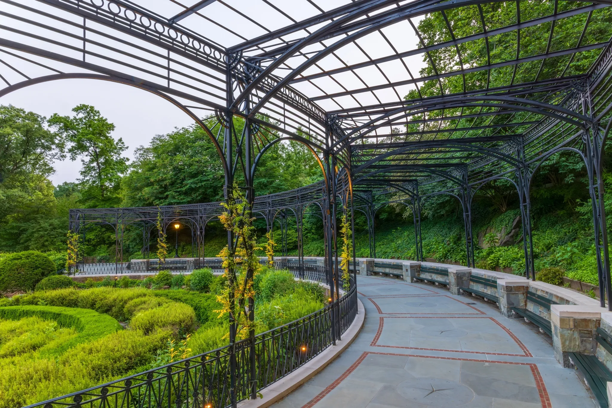 The recently restored Center Garden at dusk, showcasing the illuminated fountain and pergola