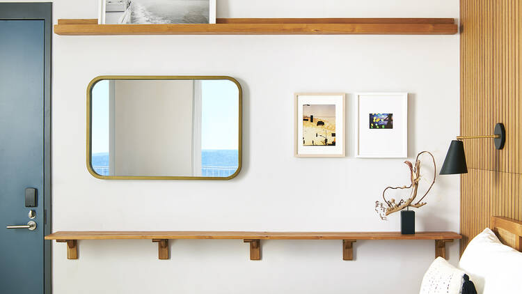 A guest room showing a bed and artwork.