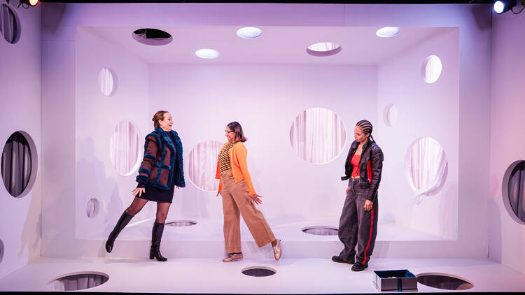 Three actors standing on stage in 'Super'.