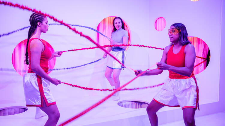 Three actors standing on stage with skipping ropes in 'Super'.