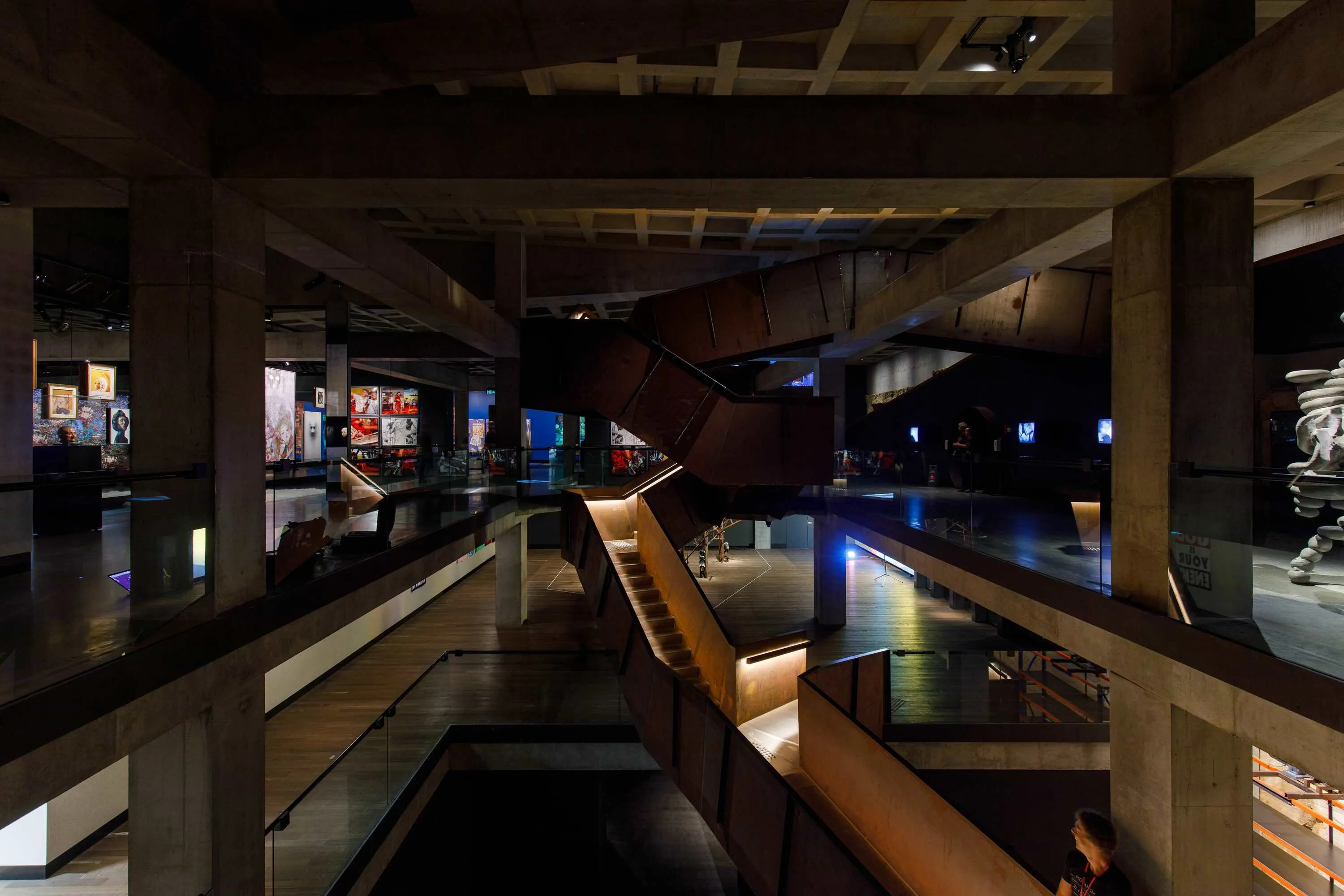 Inside of dimly-lit museum with staircase