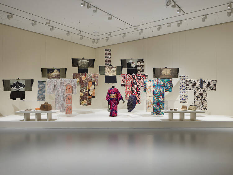 A white gallery space with kimonos on display.