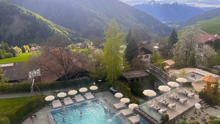 Outdoor pool and mountain view from Sonnwies Dolomites hotel