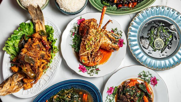A able full of fried fish, rice, and squid ink soup