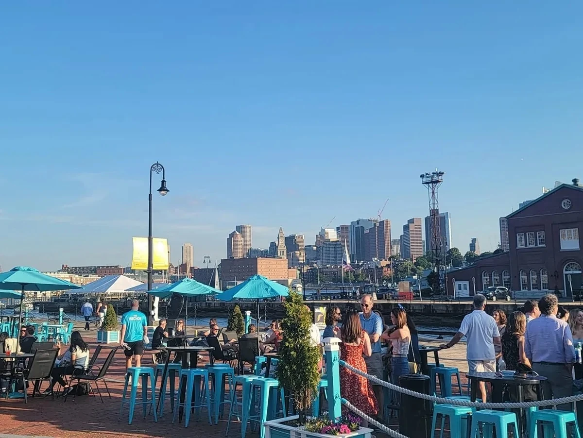 people standing and looking over Boston Harbor