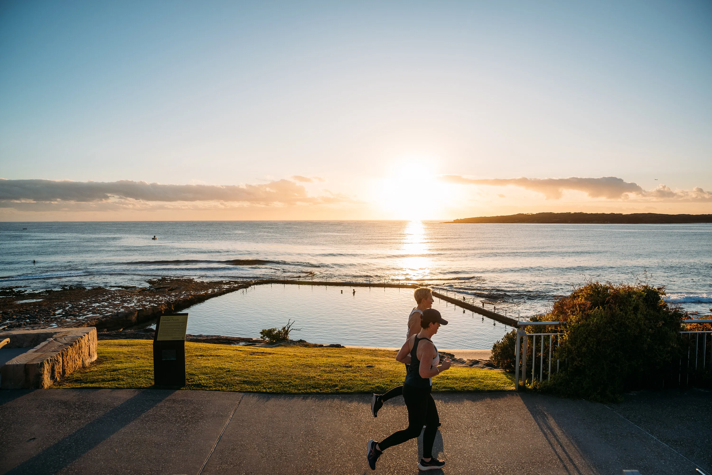 People running by a rock pool