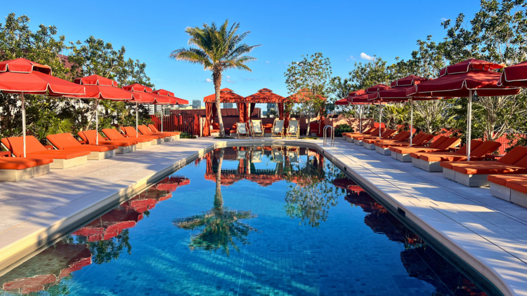Rooftop pool with orange umbrellas