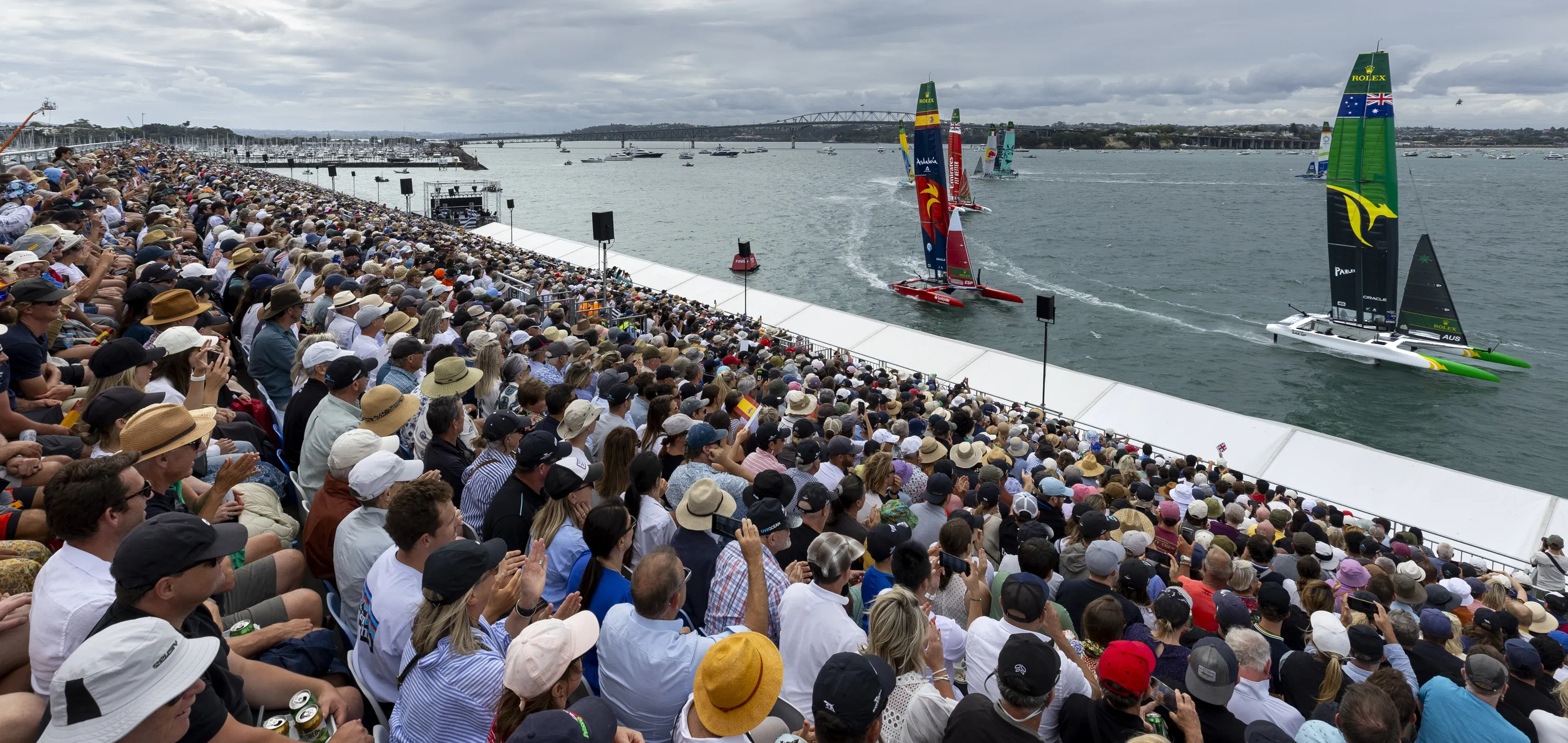 View from the grandstand as Australia SailGP Team helmed by Tom Slingsby leads the fleet on Race Day 2 of The Rolex SailGP 2025 Championship ITM New Zealand Sail Grand Prix in Auckland, New Zealand. Sunday 19 January 2025