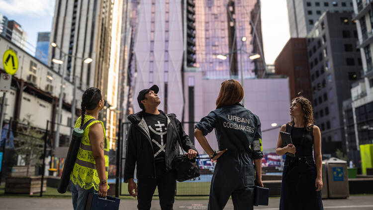 Four people looking up at buildings in Melbourne.