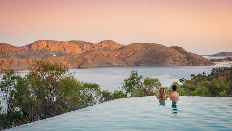 Infinity pool overlooking water and mountains