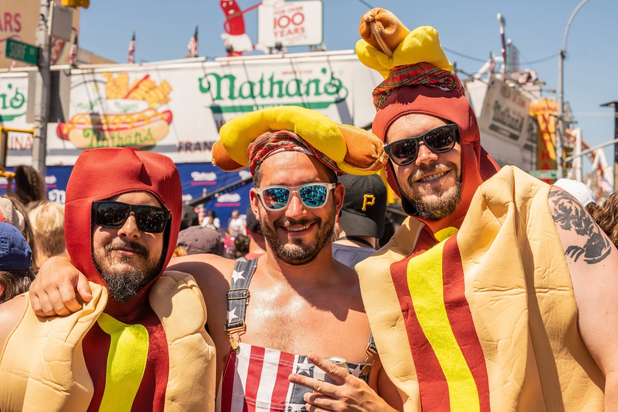 Three young men dressed up in hot dog costumes at the Nathan's World Famous Hot Dog Eating Contest on Coney Island Boardwalk in Brooklyn