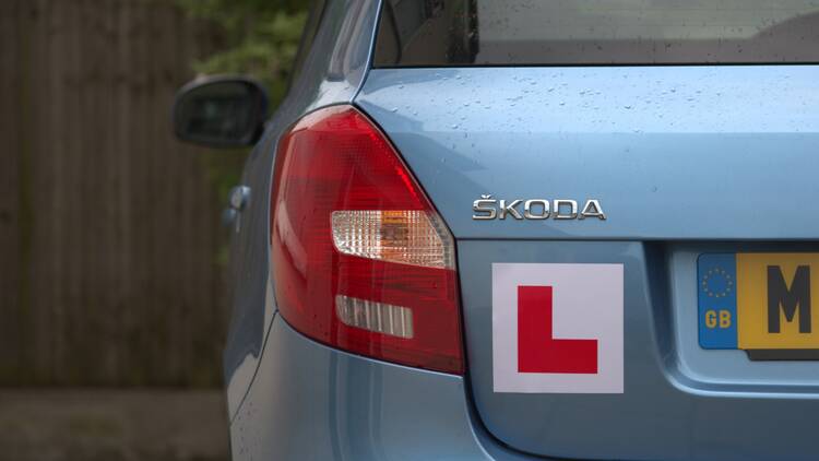 Car with an L plate 
