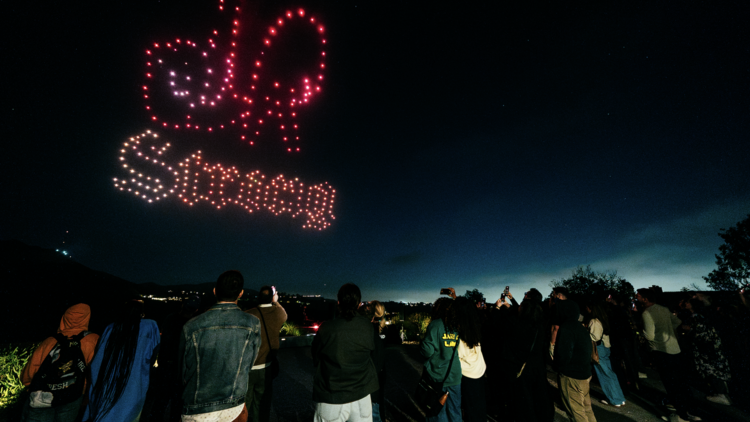 Drones spell out “L.A. Strong” in the sky, with a crowd watching.