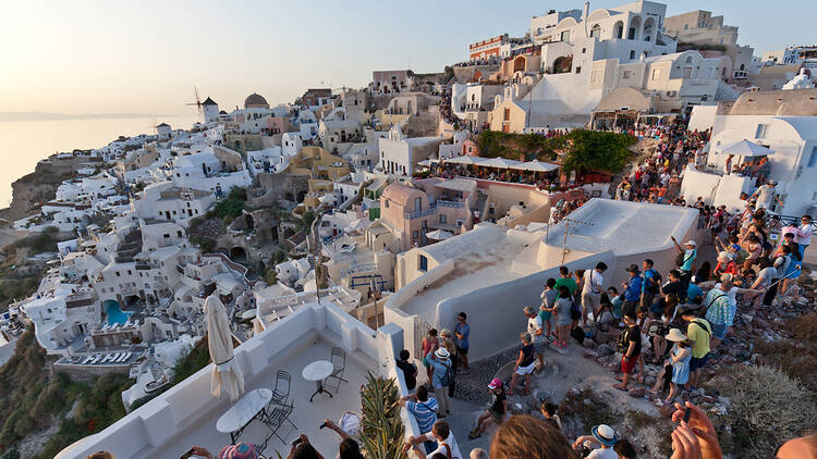 A crowd of tourists in Oia, Santorini, waiting for the sunset
