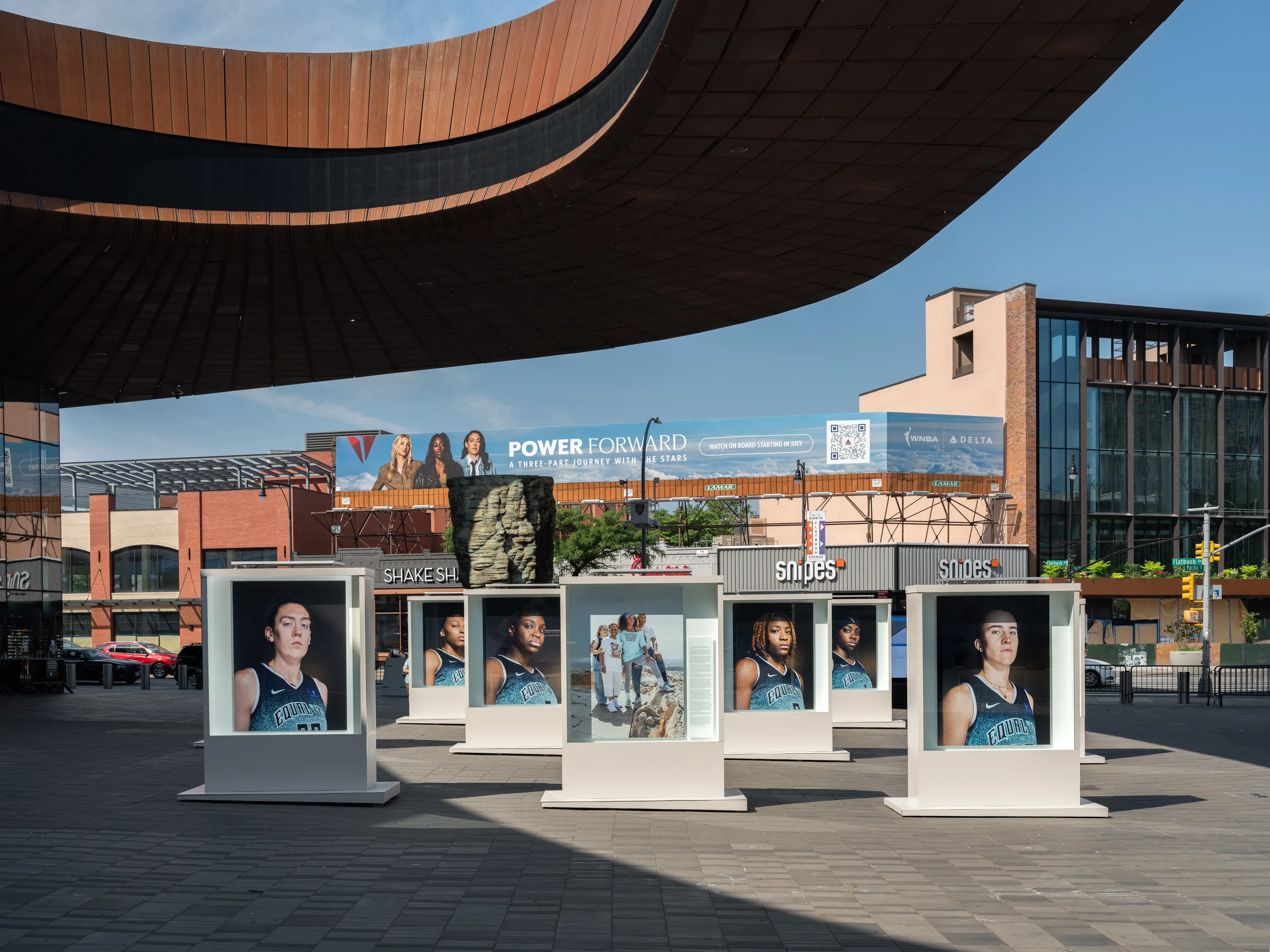 Portraits of basketball players outside of Barclays Center.