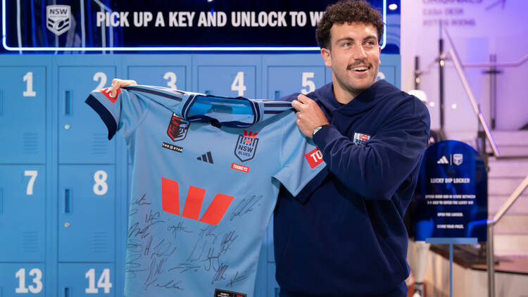 Man holding a Blues jersey