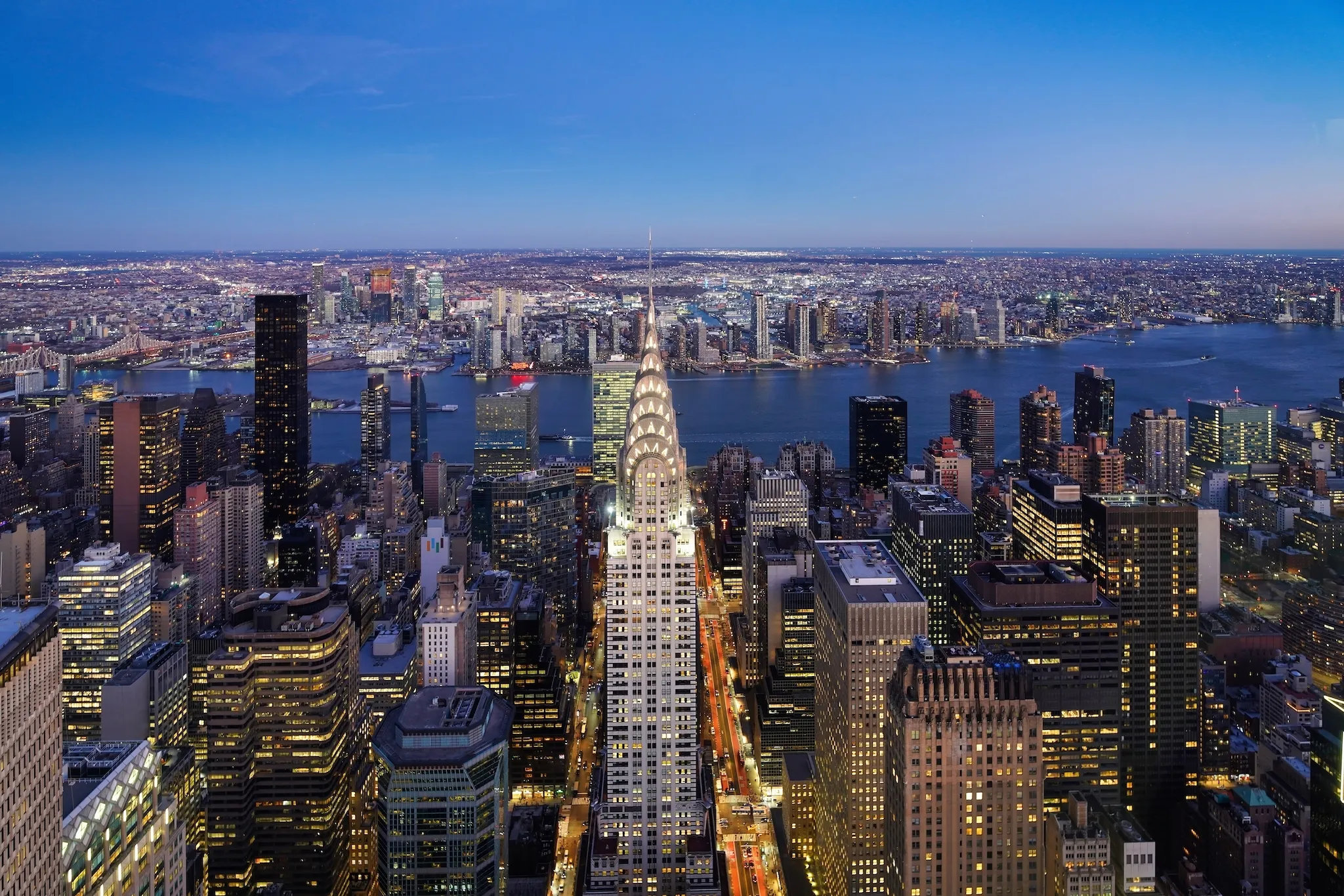 New York City at night showing the Chrysler Building and East River