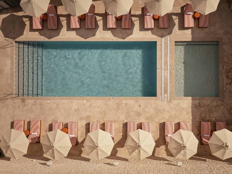 Outdoor pool with cabanas and lounges