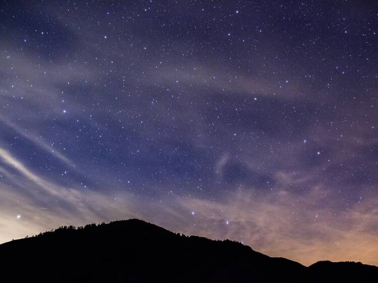 Colorful lighting reflect on the mountain with beautiful galaxy , Hehuan Mountain, night sky view, taiwan