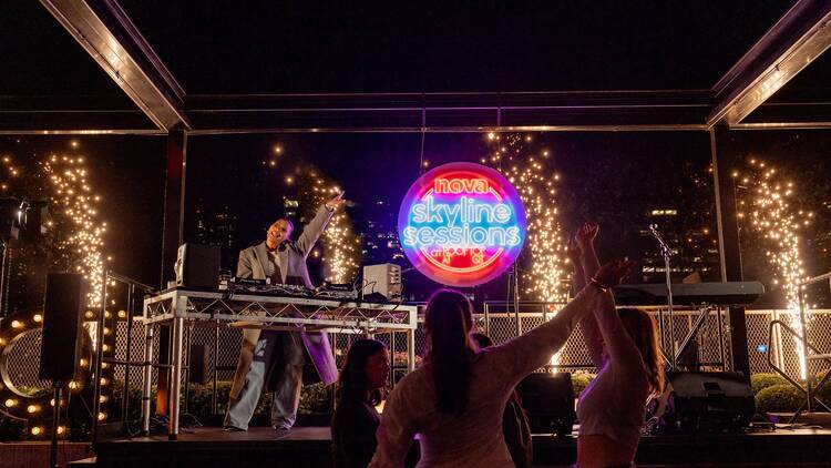 People dancing to an outdoor DJ set