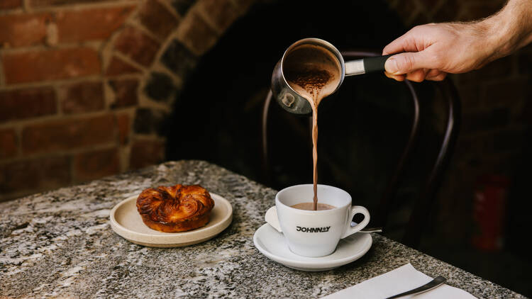 A person pouring a hot chocolate.