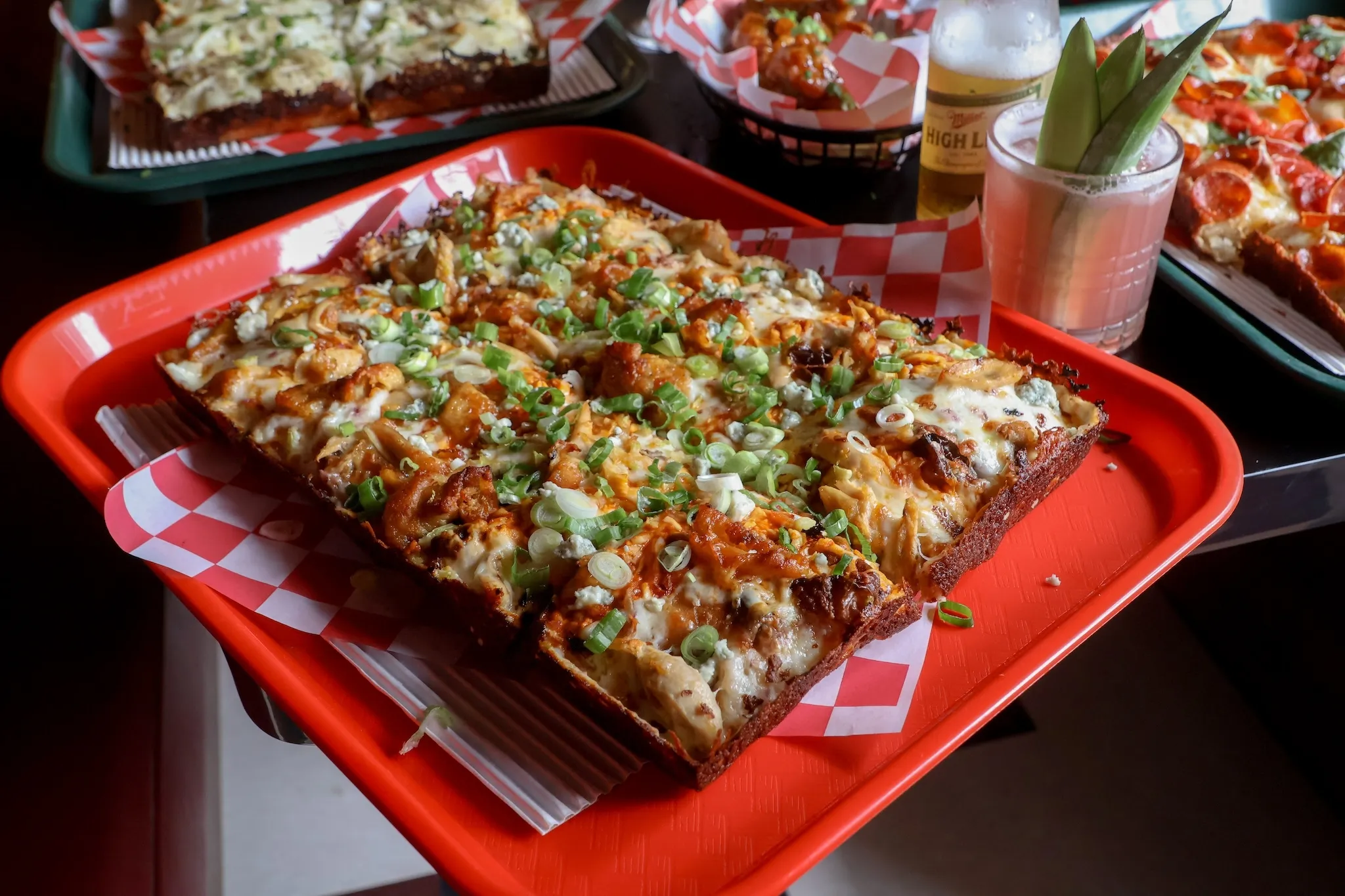 A Detroit-style pizza on a red tray