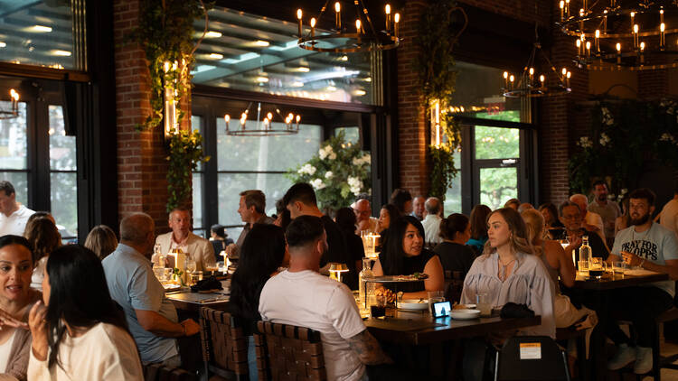A group of people sitting in a dining room 