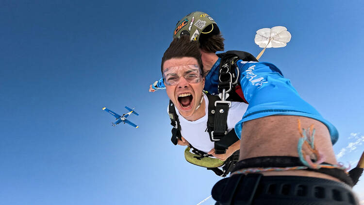 Skydiver flying in sky