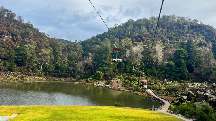Chairlift over grass and river