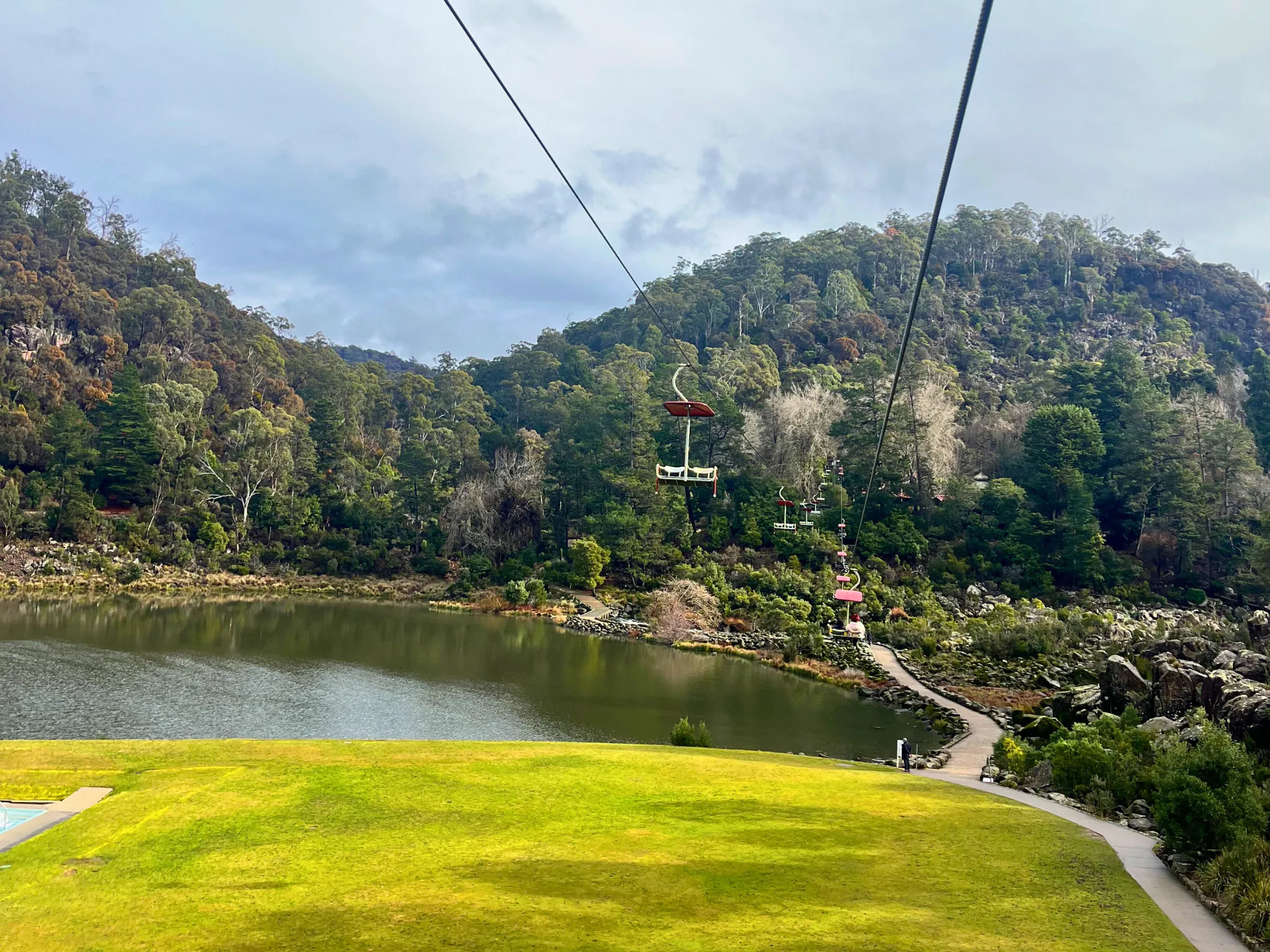 Chairlift over grass and river