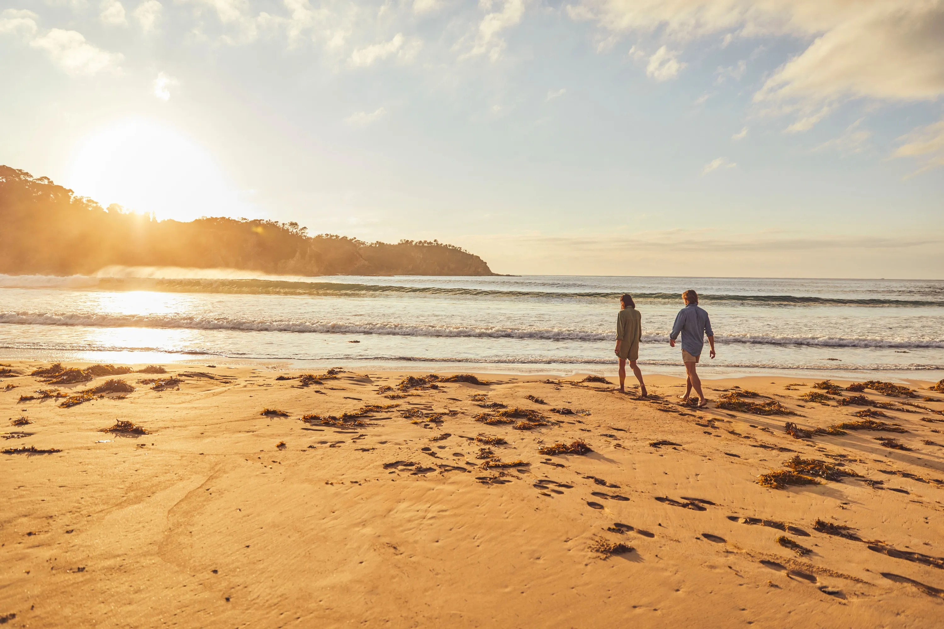 Couple enjoying a visit to McKenzies Beach, Malua Bay.
