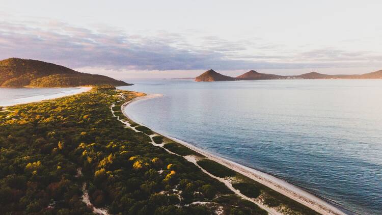 Sun rising over Bennetts Beach and Jimmys Beach, Hawks Nest.