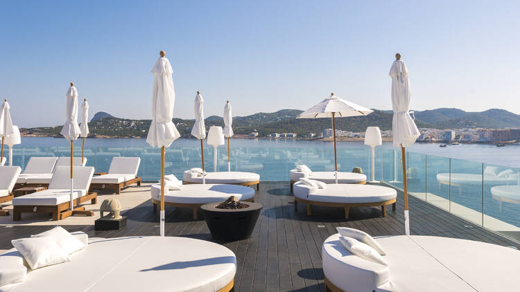 Rooftop with white sun loungers 