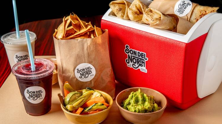 Son Del North A cooler full of burritos, guacamole and agua frescas