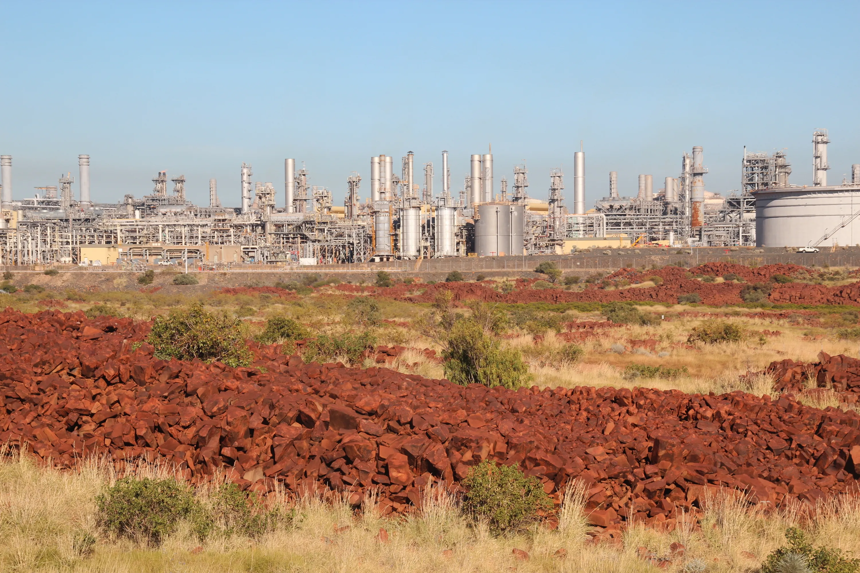 Rock art with gas processing facility in background