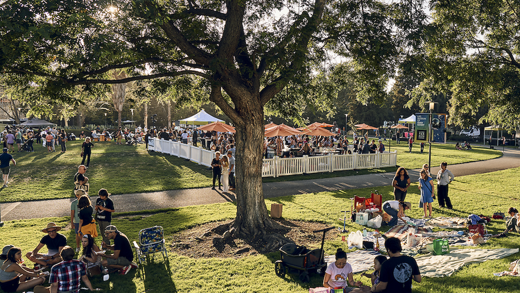 People on the grass at Summer Nights at the Tar Pits.