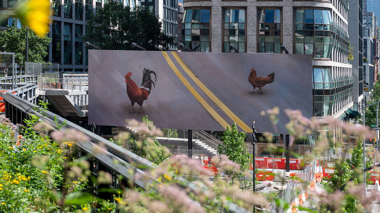 Billboard of two chickens appearing to cross the road.