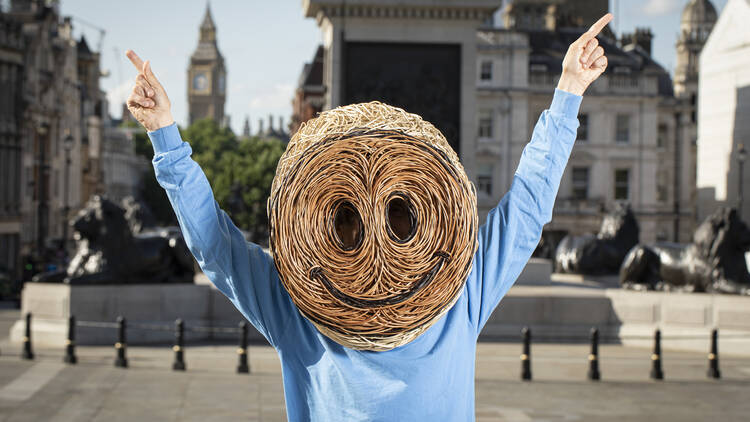 Jeremy Deller in Trafalgar Square, wearing a willow head.