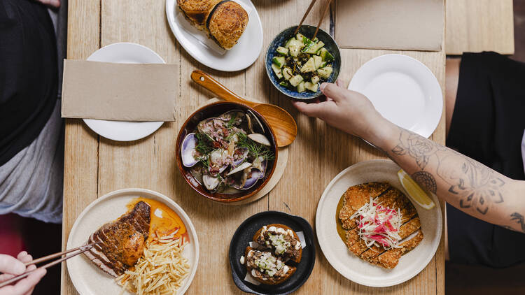 A table laden with plates of food at Benchwarmer.